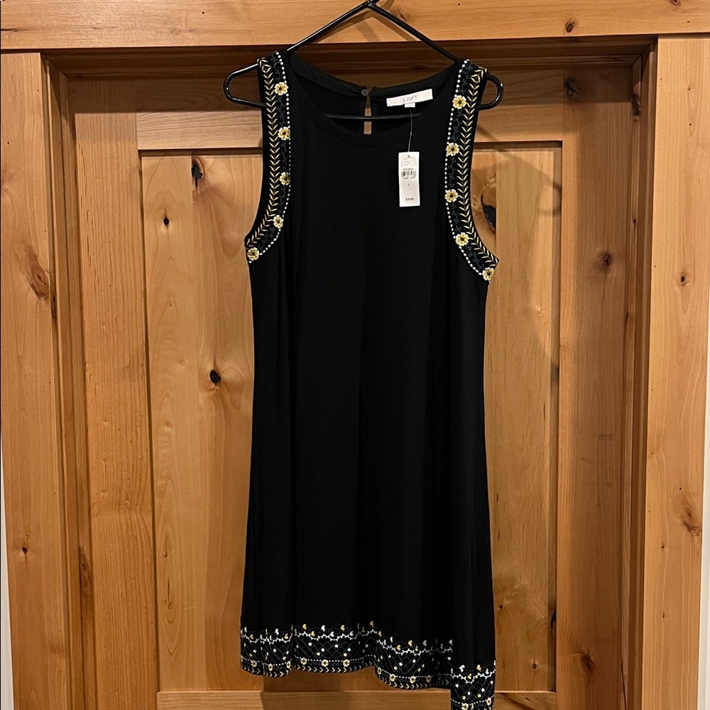LOFT Black Dress with flower Detailing at bottom hem and sleeves.